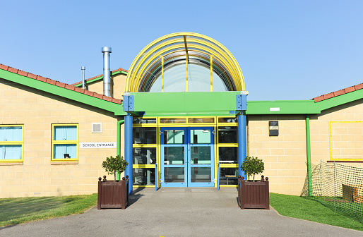 Modern school building entrance - UK infant/junior school pupils of 5-10 years