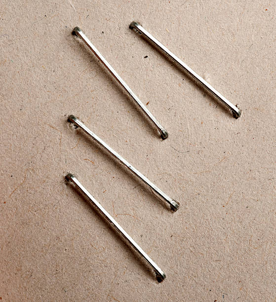 Four metal bars on brown paper background