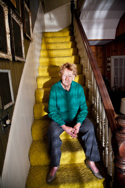 istock Senior woman sitting on staircase 184640107