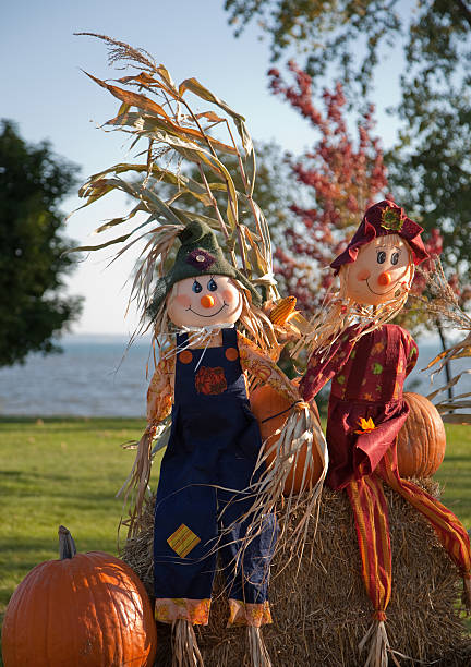 istock Happy scarecrows during autumn by the lake 184640287