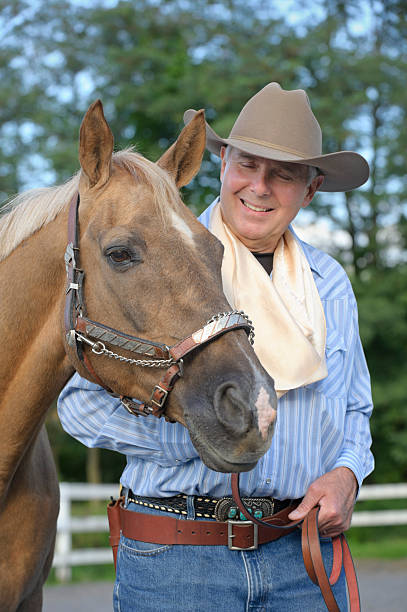 istock Cowboy Rancher with Palomino Horse 184640572