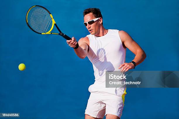 Foto de Tenista Em Fundo Azul e mais fotos de stock de Tênis - Esporte de Raquete - Tênis - Esporte de Raquete, Óculos escuros - Acessório ocular, 20-24 Anos