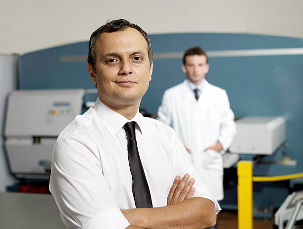 istock White collar workers in a factory 184640658