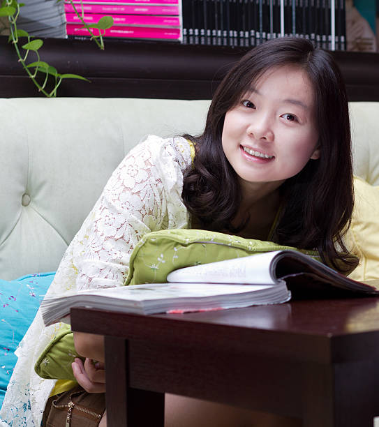 istock Young girl reading Magazine 184640709