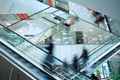 People on Two Crossed Escalators, Blurred Motion