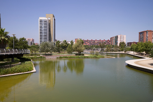 Modern apartment buildings neear a park with lake, Barcelona, Spain