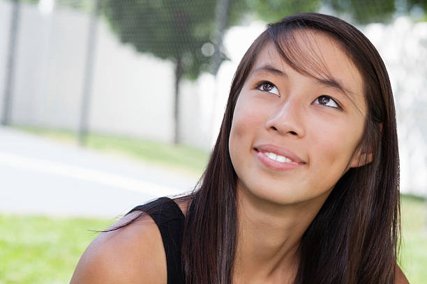 istock Young woman looking up, with copy space 184641246