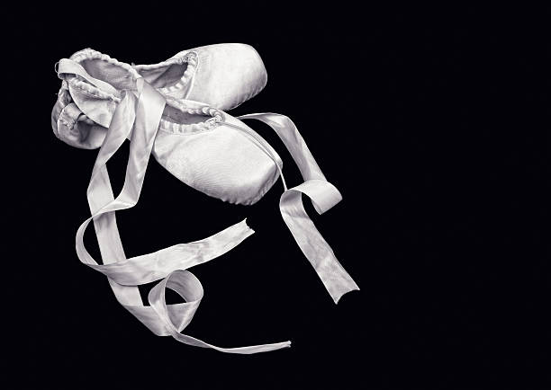 Ballet shoes isolated on black background.