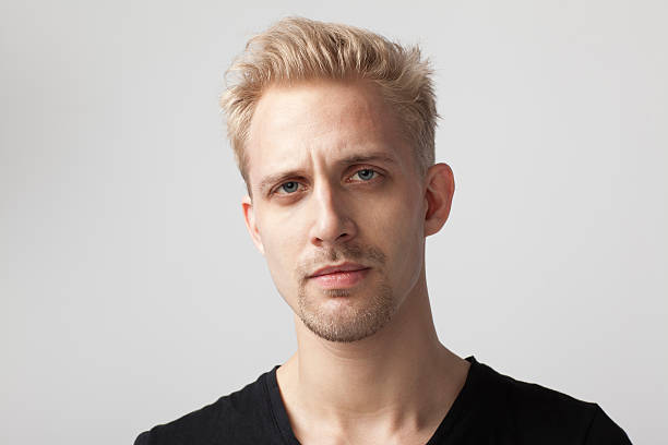 Charming confidence. Blond man. Man with unshaved mustache and beard hair with stylish haircut. Handsome man in casual tshirt on blurred natural background. Caucasian man on summer day.
