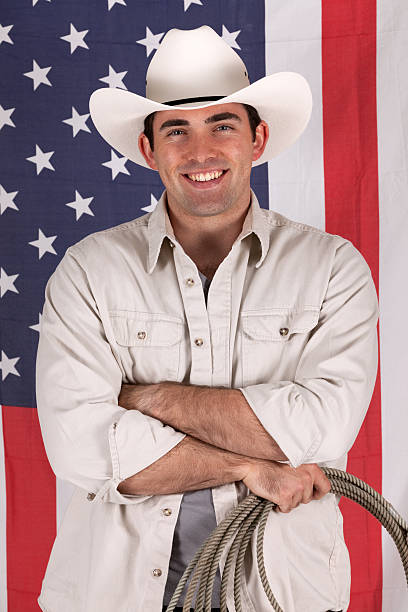 istock Cowboy standing in front of American flag 184642040