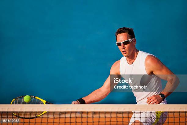 Tennis Player On The Blue Background Stock Photo - Download Image Now - 20-24 Years, Active Lifestyle, Activity