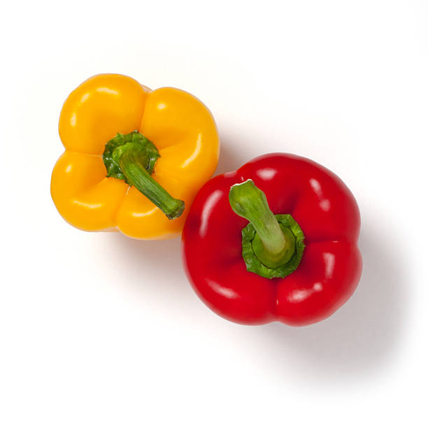 istock Two red and yellow peppers on white background, from above 184643102