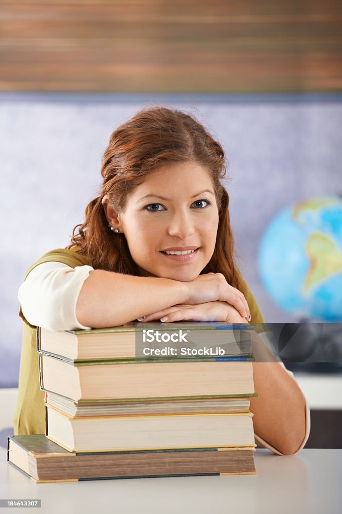 Portrait of female student with books Portrait of female student with books looking at camera, smiling. 16-17 Years Stock Photo