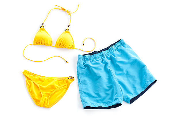 yellow bikini and blue beach short yellow bikini and blue beach short isolated on white swimwear stock pictures, royalty-free photos & images