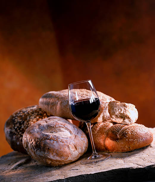 istock rustic italian bread loafs and glass of red wine 184643739