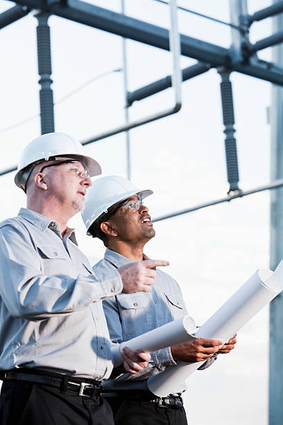 istock Multiracial engineers at industrial site looking up 184643740