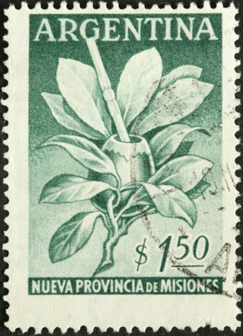 old Argentine postage stamp with leaves and drinking cup