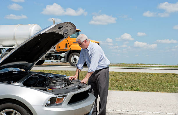 businessman with broken down car stock photo