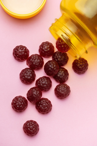 Vitamins for children,   jelly gummy fruits candy on pink  background