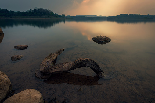 landscape of a sunset over the water of the lake with timber- Image