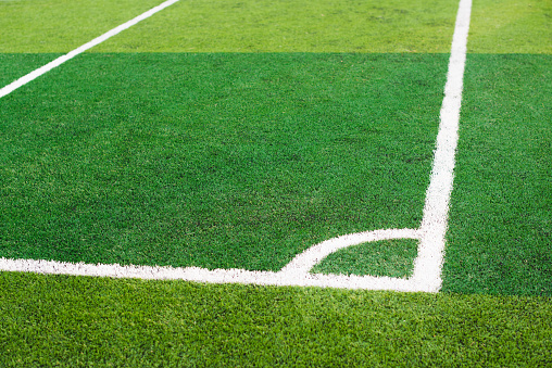 White line corner on the green soccer field