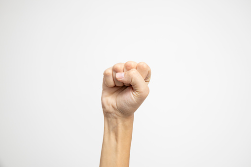 A clenched fist, symbolizing strength or determination, displayed against a clean white background.