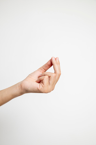 The fingers forming a connection with the index, middle, and thumb joined together create a symbolic gesture against a clean white background.