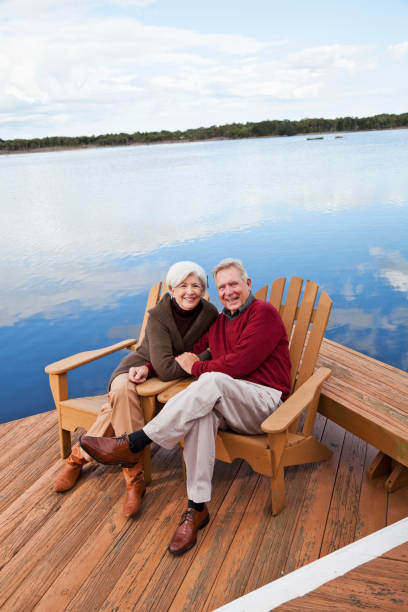 istock Senior couple sitting by water 184644729