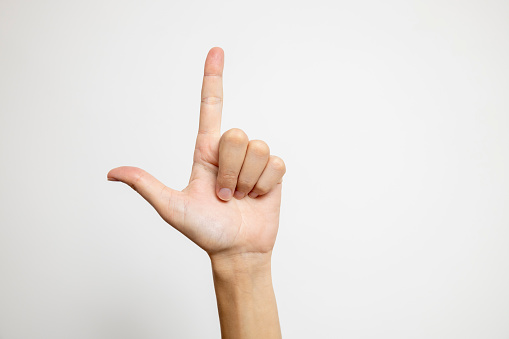 The index finger of the hand prominently appears against a pristine white background.