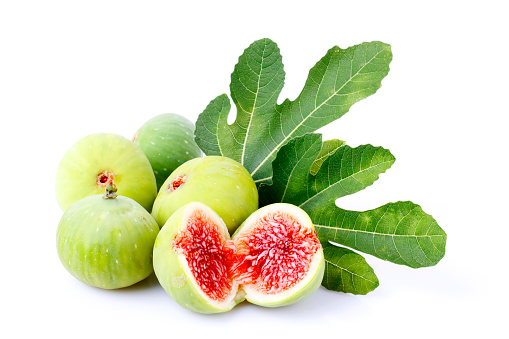 fresh ripe figs fruit and olive branch on dark table. mediterranean food concept