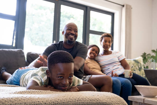 istock African family together on the sofa watching television 1846460658