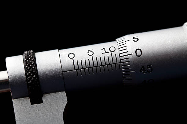 Micrometer measurement isolated on clean black background An isolated image of a micrometer on a black background. Shallow focus is on the scale. Adobe RGB 1998 profile. micron stock pictures, royalty-free photos & images