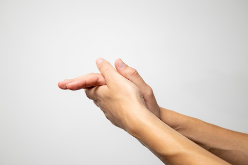 A man meticulously washing his hands, emphasizing hygiene and cleanliness, against a pristine white background.