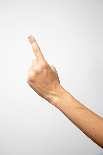 A solitary index finger points to the left against a clean white background.