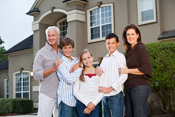 istock Big family standing outside house 184646405