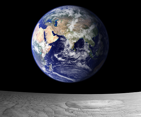 A blue Earth rising from the lunar surface.