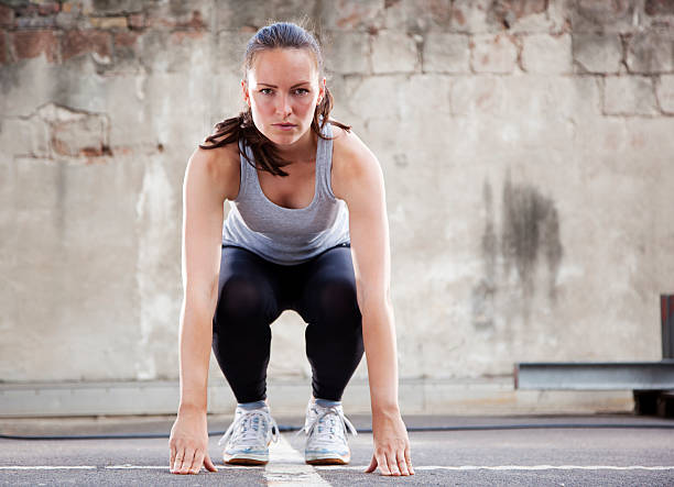 Young woman doing Burpee exercise stock photo