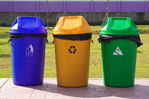 Standard wheeled plastic garbage bin; isolated on white.