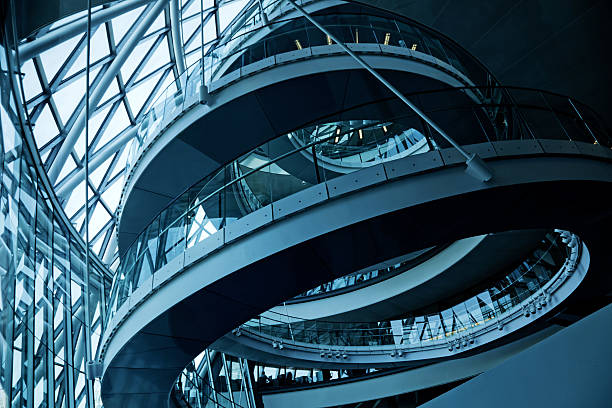 London City Hall Looking up at a spiral walkway in City Hall beside the River Thames and Tower Bridge in London, UK. gla building stock pictures, royalty-free photos & images