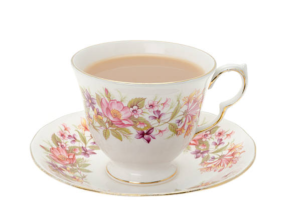 Cup of tea. A cup of hot tea served in an ornate patterned cup and saucer - studio shot. tea cup and saucer stock pictures, royalty-free photos & images