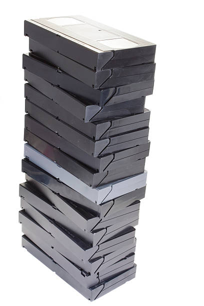 Stack of VCR tapes "Photo of a stack of vcr tapes, isolated on white" audio cassette blank vcr film reel stock pictures, royalty-free photos & images