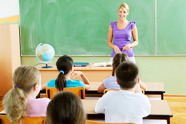 istock Female Teacher Questioning little students 184647040