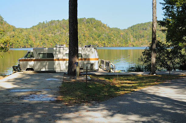 istock Shaded campsite in autum with old motorhome 184647398