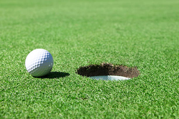 istock Golf Ball On Edge of Hole 184647716