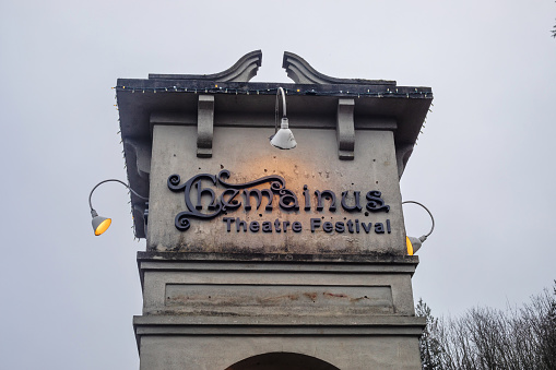 Chemainus, Canada - December 10, 2023. The sign for the Chemainus Theatre is illuminated near dusk.