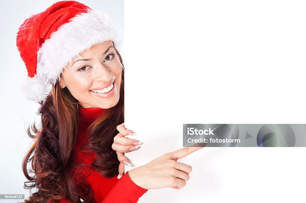 Femme avec Chapeau de Père Noël pointant à vide, Bannière - Photo de Montrer du doigt libre de droits