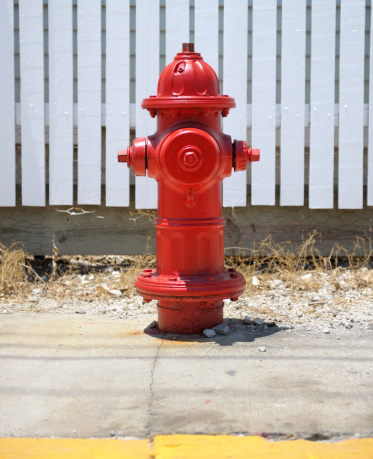 Metal red paint fire hydrant in a urban area - image with copy space
