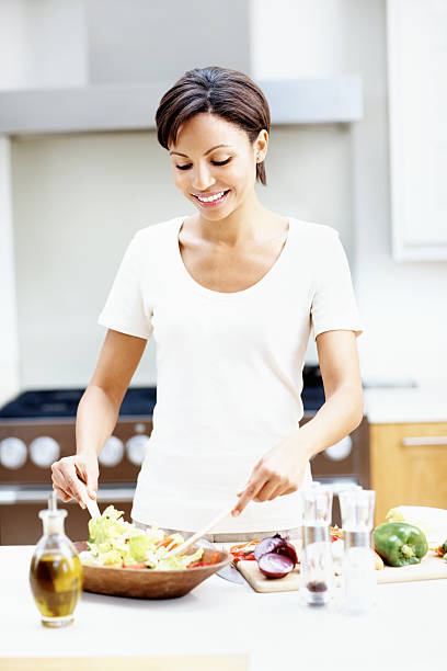 istock Woman preparing salad in kitchen 184649059