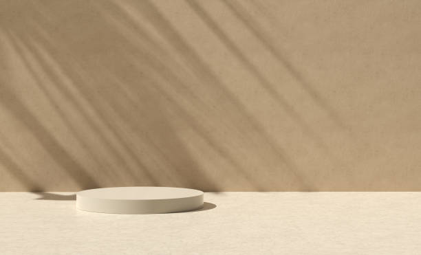 istock Premium beige podium or platform with geometric cylindrical shape with palm leaf shadows on the stucco wall. 1846491845