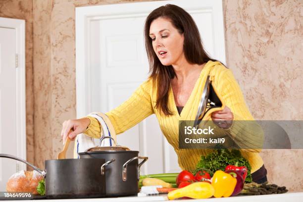 Woman In Kitchen Cooking On Stove Stock Photo - Download Image Now - Cooking Pan, One Woman Only, Women